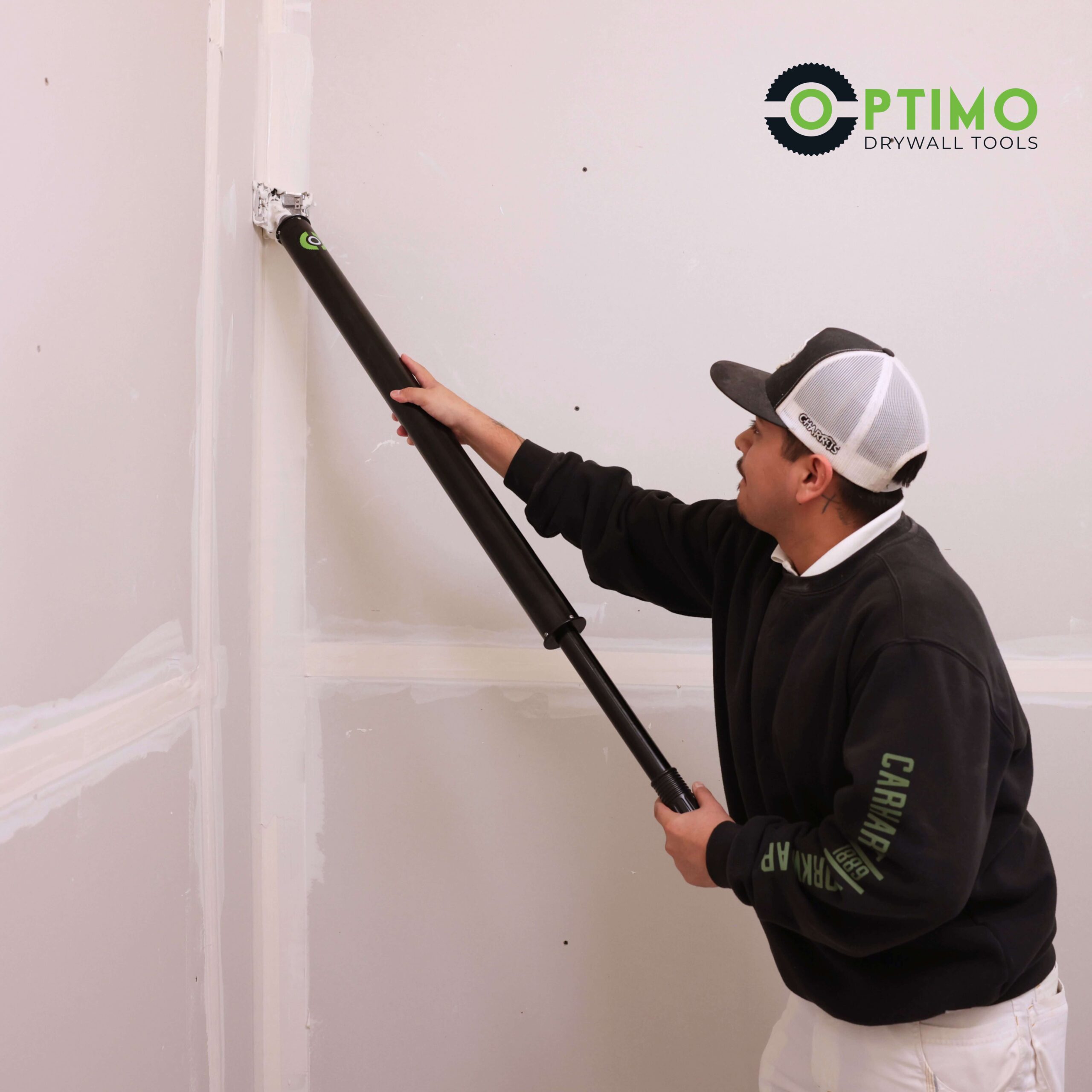 Optimo compound tube being used by a drywaller